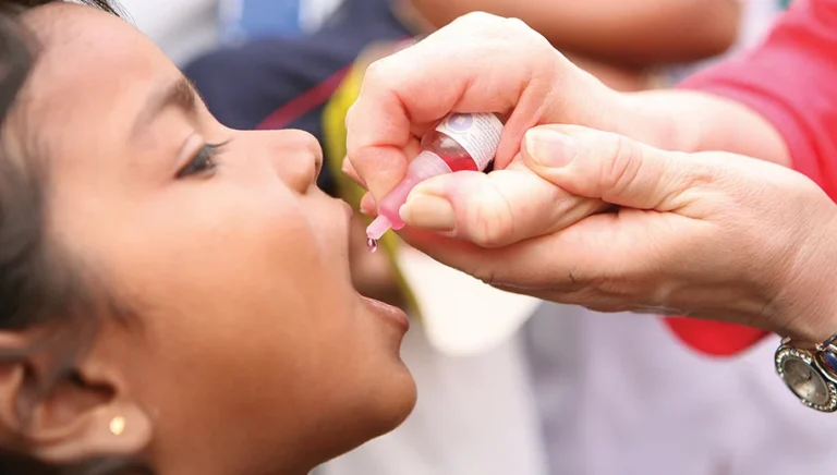 Health workers administer polio drops to children during the anti-polio campaign in Mardan district.