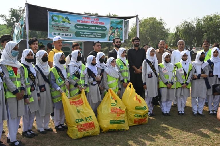 Volunteers and students participate in a CDA cleanliness drive around Rawal Dam, Islamabad