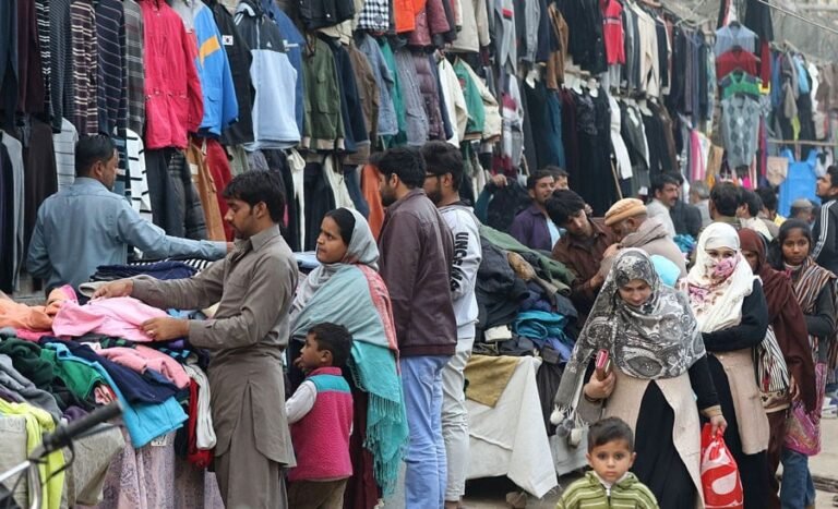 Shoppers browsing winter clothes at Landa Bazar after price hike due to new import tax.