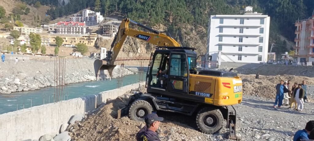 Excavators demolishing illegal constructions along Swat River in Kalam