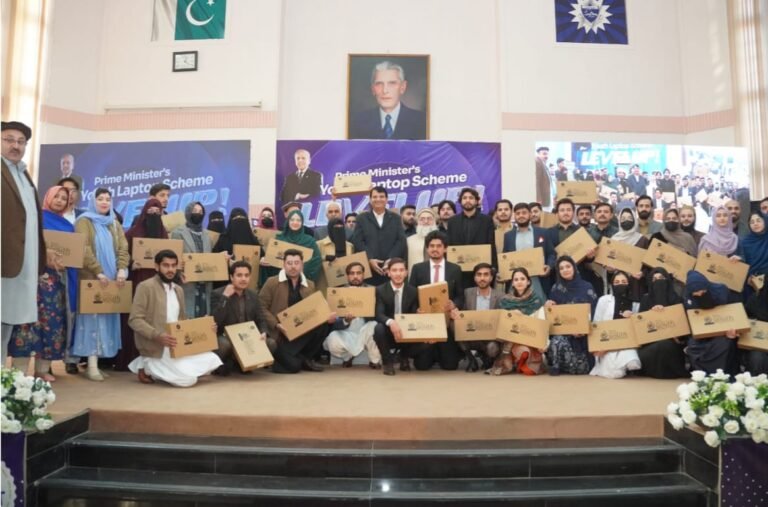 Federal Minister Amir Muqam distributes laptops to KP university students under the PM Youth Program.