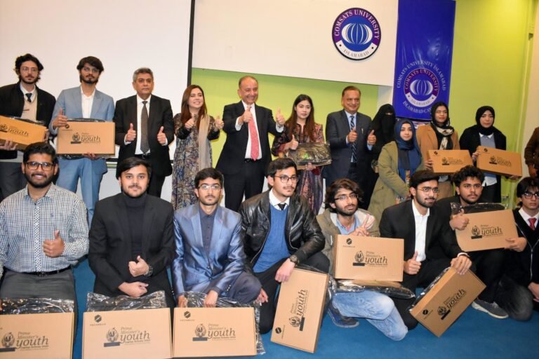 Students receive laptops at COMSATS University Islamabad during the Prime Minister Youth Laptop Scheme ceremony.