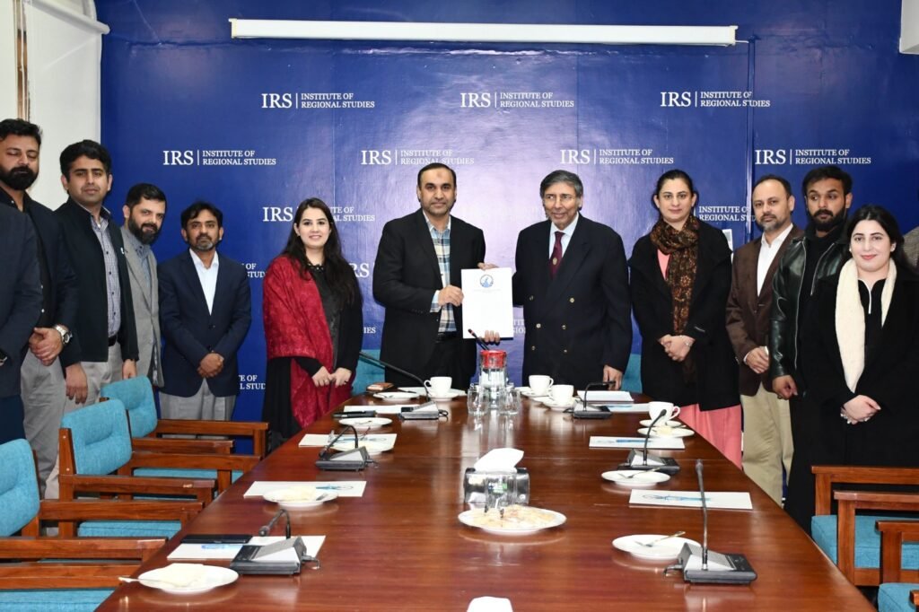 Officials from IRS and PKCERT exchange documents during the MoU signing ceremony on cybersecurity cooperation in Islamabad.
