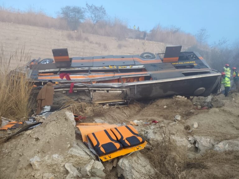 Rescue teams operate at the site where a passenger bus plunged into a ravine near Talagang in Chakwal district.