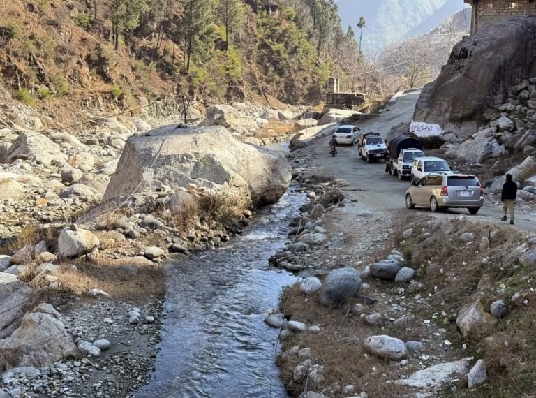 Damaged sections of the Karora–Ajmer road in Shangla district amid stalled construction work.