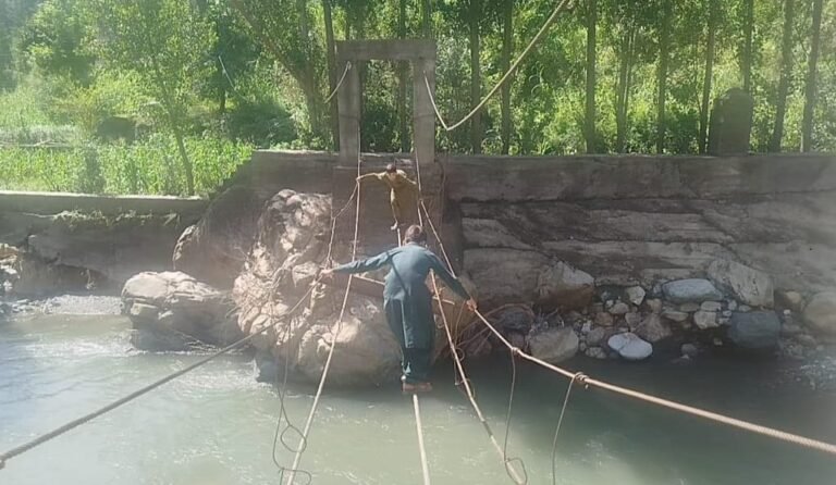 Residents crossing icy stream after bridge destruction in Shangla’s Faizabad area