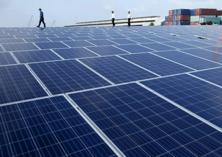 Engineers inspecting solar panels at the Pakistan-Korea PV Module Testing Laboratory in Islamabad.