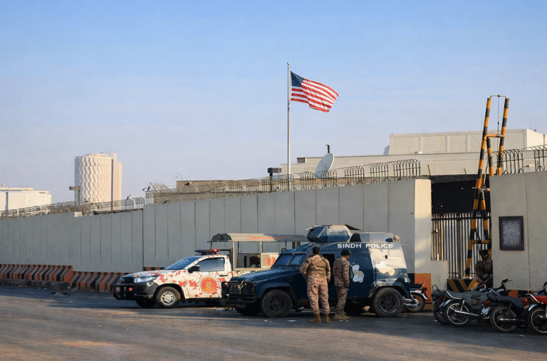 Security forces stand guard outside the US consulate in Karachi after US Marines fired during a protest breach.