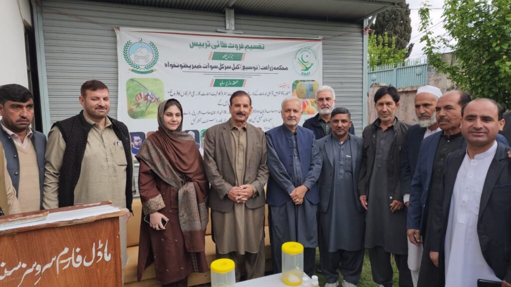 Farmers in Swat receive free fruit fly traps during a distribution ceremony at Kabal Farm Services Centre.