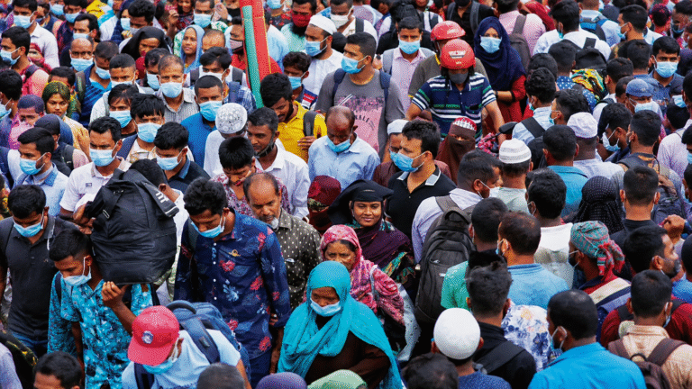 People gathered in a crowded urban area in Pakistan amid rising population projections