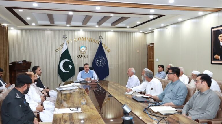 Swat officials discuss bus stand facilities and Malam Jabba tourism infrastructure during a meeting chaired by the deputy commissioner.