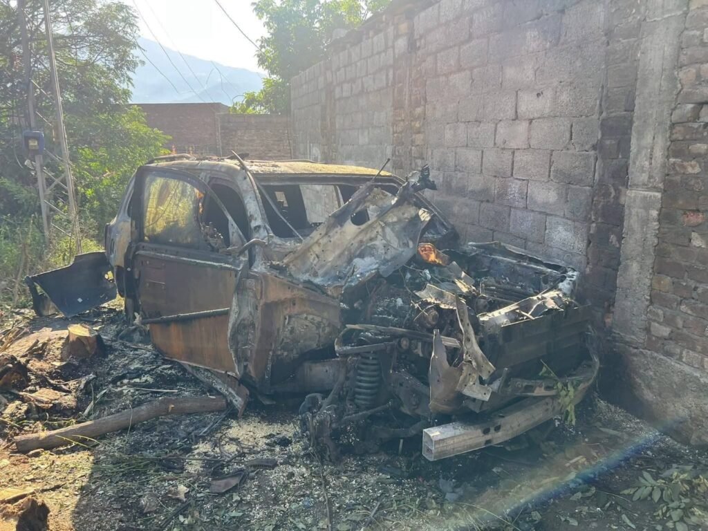 Police investigate the site of a convoy attack in Swat that killed three people and injured Afzal Gujjar.