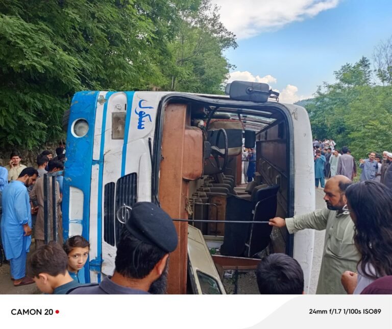 Rescue workers assist injured students after a school bus overturned in Matta Tehsil, Swat.