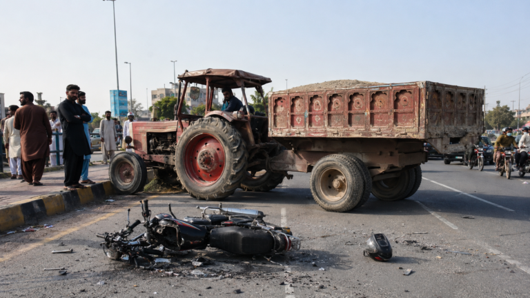 Police examining accident scene in Lahore Kahna after a tractor trolley U-turn collision killed a motorcyclist.