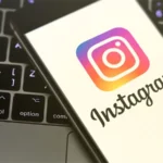 Instagram logo displayed on a smartphone as the social media platform tests a new feature allowing selected creators to upload videos lasting up to 90 minutes.