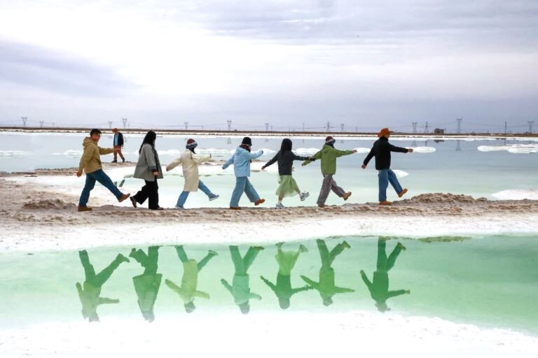 The emerald-colored brine and salt ponds of Qairhan Salt Lake in Qinghai, where mineral production and tourism coexist.