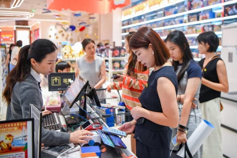 Construction and commercial activity at the Hainan Free Trade Port following customs reforms that boosted investment and trade.