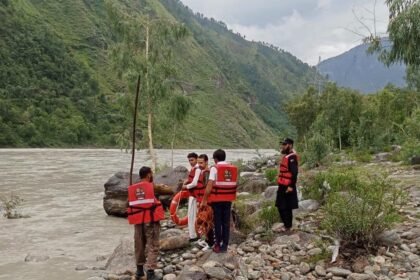 Heavy machinery clears a monsoon-triggered landslide from the Alpuri–Bisham highway in Shangla