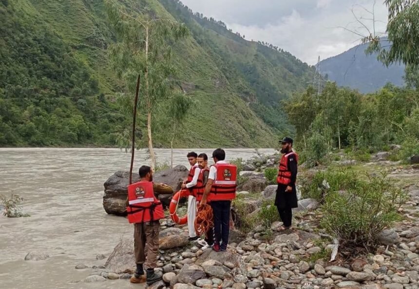 Heavy machinery clears a monsoon-triggered landslide from the Alpuri–Bisham highway in Shangla