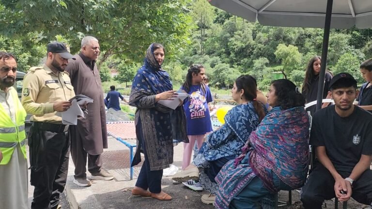 KPCTA officials distribute tourist safety awareness material during the Abbottabad campaign launch.