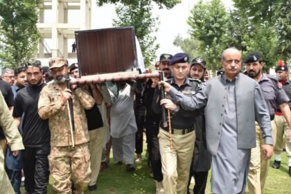 Police officers attend the funeral of Elite Force constable Gulfam Khan following the Shalkho Sar counterterrorism operation in Swat.
