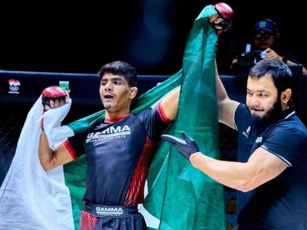 Pakistani MMA fighters Muhammad Jawad Ahmed and Muhammad Saqib celebrating their gold medal victories at the GAMMA Asian MMA Championship in Malaysia.