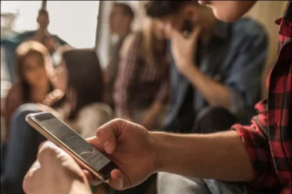 A smartphone user experiencing thumb and wrist pain after prolonged typing and scrolling.