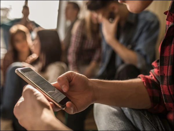 Thumb Hurts After Scrolling? Your Smartphone Habits May Be the Reason A smartphone user experiencing thumb and wrist pain after prolonged typing and scrolling.