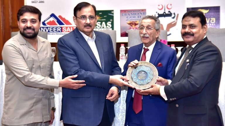 Punjab Law Minister Rana Muhammad Iqbal Khan presents awards to lawyers and business leaders during a ceremony in Lahore.