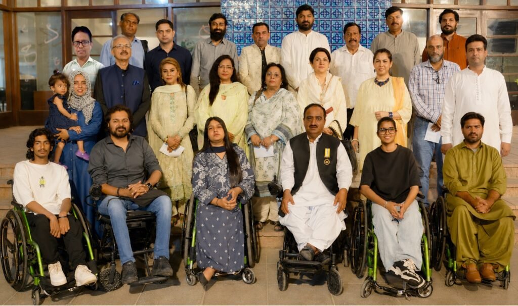 Javed Rais receives recognition during a Halqa-e-Fikr-o-Nazar ceremony honoring his contributions to disability rights in Pakistan.