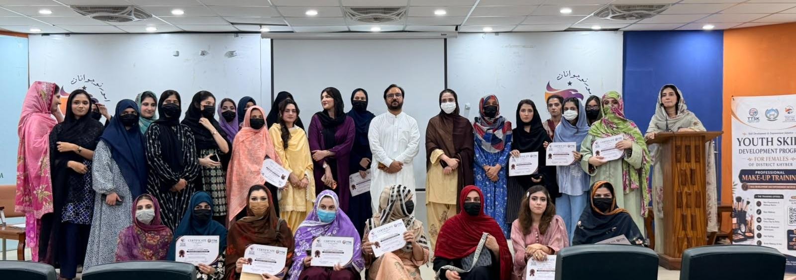 Women receive certificates after completing professional makeup training in Peshawar