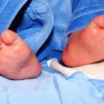 Rescue workers recover a newborn baby girl found alive in a dustbin near a Lahore railway crossing.
