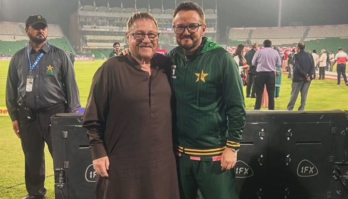 Mike Hesson’s Father Joins Crowd Mike Hesson poses with his father during the Pakistan-England match at Gaddafi Stadium.