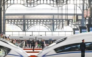 Passengers board a high-speed train in China as railway travel reaches a record 3.71 billion trips during the first nine months of 2026.