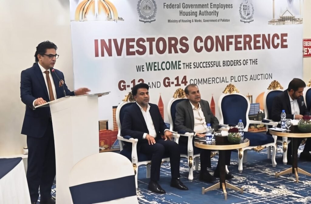 FGEHA Director General Capt. (Retd.) Zafar Iqbal distributes acceptance letters and awards to successful investors at a conference in Islamabad.