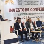 FGEHA Director General Capt. (Retd.) Zafar Iqbal distributes acceptance letters and awards to successful investors at a conference in Islamabad.