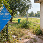 Poorly maintained multi-purpose sports ground in Islamabad with litter, overgrown vegetation and damaged facilities under CDA civic management.