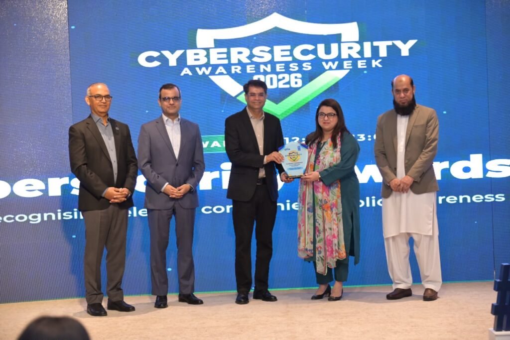 Federal IT Minister Shaza Fatima Khawaja presents the PTA cybersecurity excellence award to PTML officials Awais Vohra and Shan Haq in Islamabad.