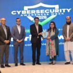 Federal IT Minister Shaza Fatima Khawaja presents the PTA cybersecurity excellence award to PTML officials Awais Vohra and Shan Haq in Islamabad.