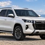Unofficial AI-generated rendering of the 2027 Toyota Fortuner showing a possible Hilux-inspired front design based on camouflaged test vehicles spotted in Thailand.
