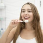 Healthy teeth and gums illustration showing how vegetables, fruits and a balanced diet support oral health alongside regular brushing.