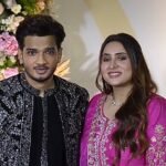 Munawar Faruqui arrives at Mr Faisu's wedding reception with his wife.